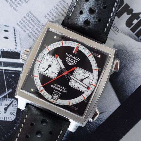 The red and white elements are in contrast to the black dial.